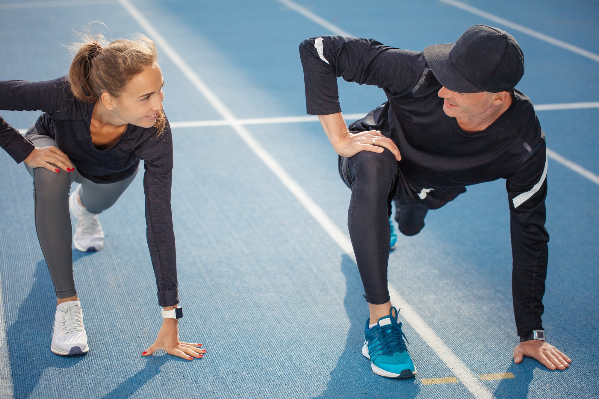 Stretching on track before workout